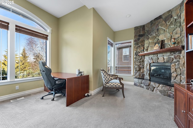 home office with light carpet, a fireplace, and plenty of natural light