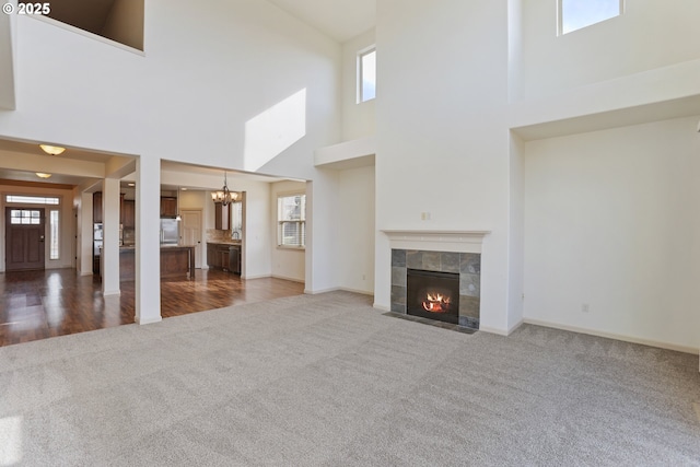 1455 NE Cooper Ln, Estacada, OR 97023 - unfurnished living room with a notable chandelier, a fireplace, baseboards, and carpet