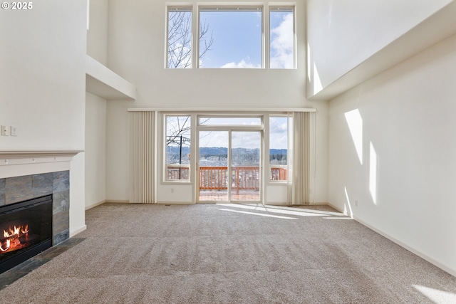 1455 NE Cooper Ln, Estacada, OR 97023 - unfurnished living room featuring carpet flooring, baseboards, a towering ceiling, a mountain view, and a tile fireplace