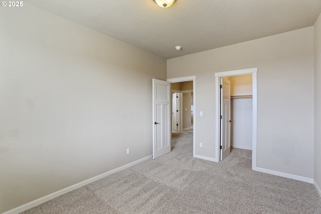 1455 NE Cooper Ln, Estacada, OR 97023 - unfurnished bedroom with a spacious closet, baseboards, a textured ceiling, light carpet, and a closet