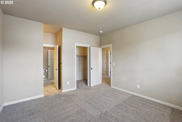 1455 NE Cooper Ln, Estacada, OR 97023 - unfurnished bedroom featuring carpet floors, a closet, baseboards, and a textured ceiling