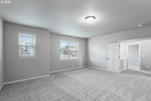 1455 NE Cooper Ln, Estacada, OR 97023 - unfurnished bedroom with carpet, a textured ceiling, and multiple windows