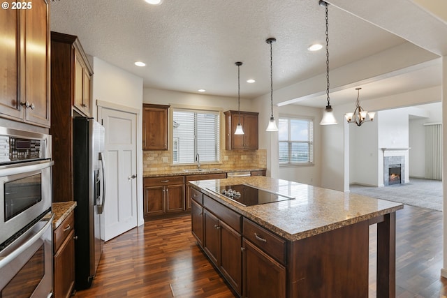 1455 NE Cooper Ln, Estacada, OR 97023 - kitchen with a sink, appliances with stainless steel finishes, a center island, open floor plan, and dark wood-style flooring