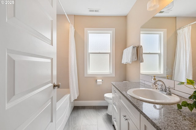 4926 NE 12th Ave, Portland, OR 97211 - full bath featuring vanity, toilet, baseboards, marble look tile flooring, and shower / bath combination with curtain