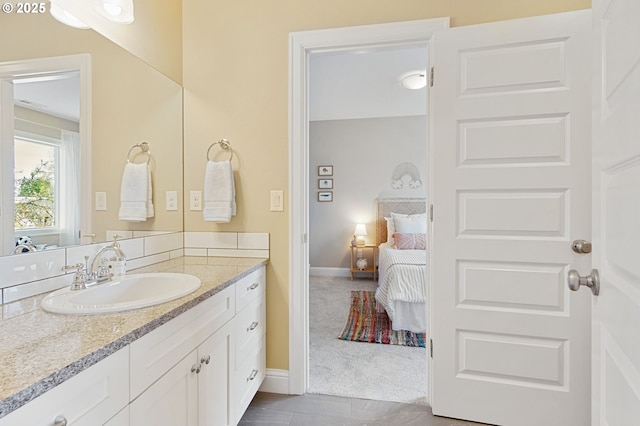 4926 NE 12th Ave, Portland, OR 97211 - bathroom with vanity, ensuite bathroom, and baseboards