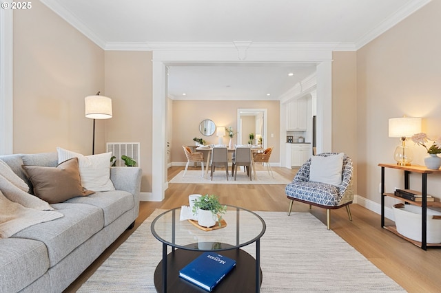 4926 NE 12th Ave, Portland, OR 97211 - living room featuring light wood-style flooring, baseboards, ornamental molding, and recessed lighting
