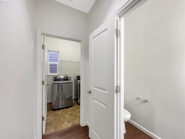 10095 NW Curtis St, North Plains, OR 97133 - corridor with washing machine and dryer, dark wood-style floors, and baseboards
