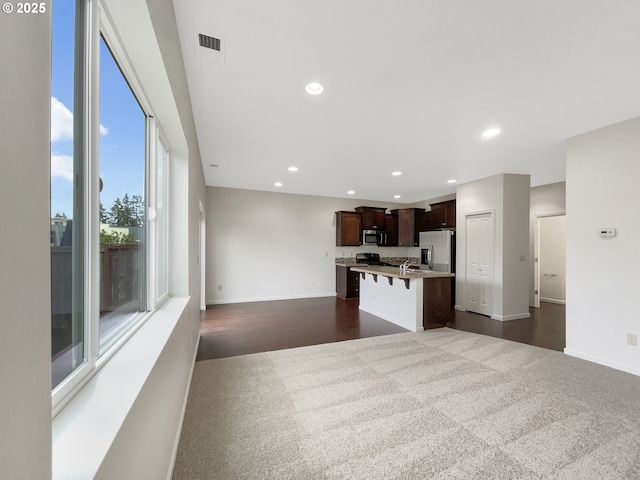 10095 NW Curtis St, North Plains, OR 97133 - unfurnished living room featuring baseboards, recessed lighting, and dark carpet