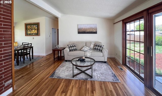 1214 NE Loper Ave, Prineville, OR 97754 - living area featuring wood finished floors, baseboards, and a textured ceiling