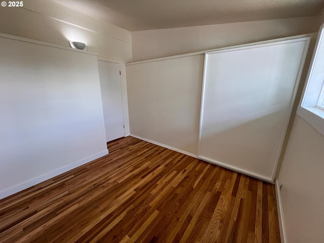 1214 NE Loper Ave, Prineville, OR 97754 - unfurnished bedroom with wood finished floors, a closet, and baseboards