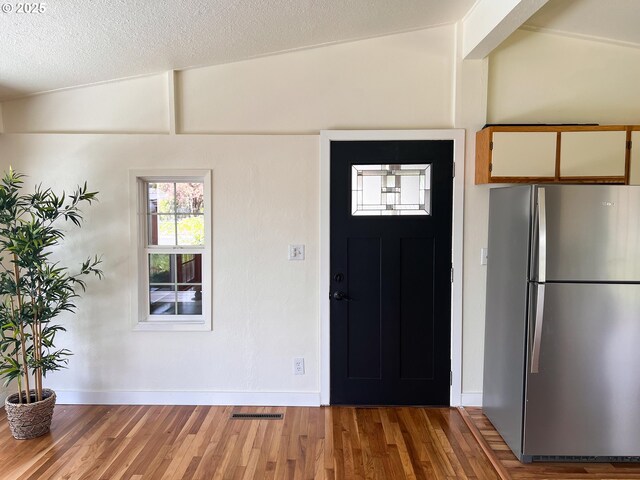 1214 NE Loper Ave, Prineville, OR 97754 - foyer entrance featuring baseboards, light wood-style floors, and a textured ceiling