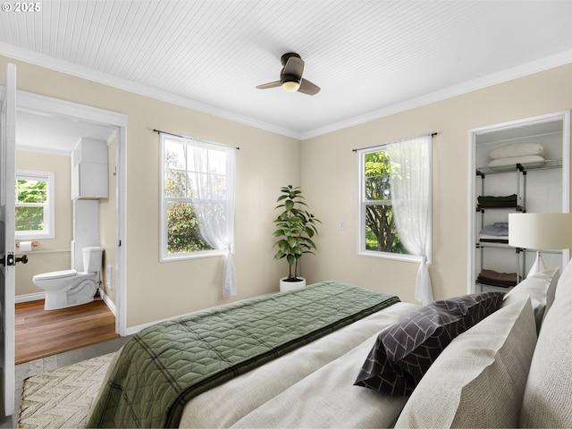 bedroom featuring baseboards, ornamental molding, a ceiling fan, and wood finished floors