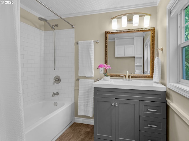 full bathroom featuring crown molding, shower / tub combo with curtain, wood finished floors, and vanity