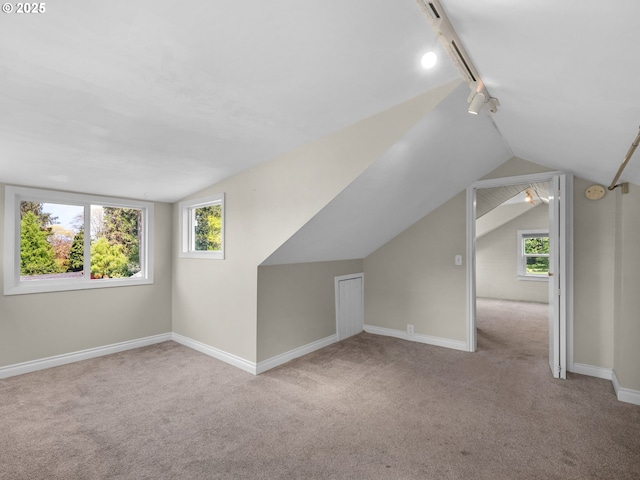 bonus room with carpet flooring, vaulted ceiling, and plenty of natural light