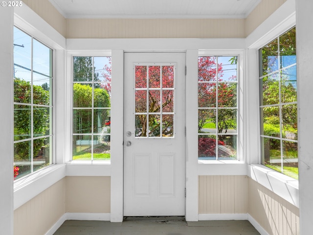 doorway to outside featuring baseboards and a wealth of natural light