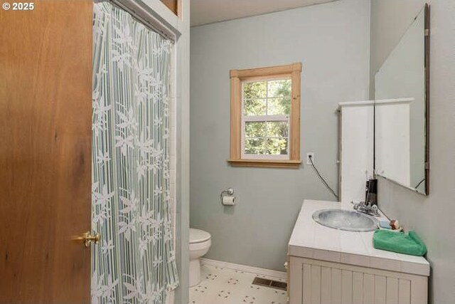 22885 S Tendril Ln, West Linn, OR 97068 - bathroom featuring vanity, toilet, baseboards, and curtained shower