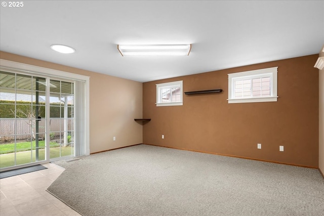 carpeted empty room featuring baseboards