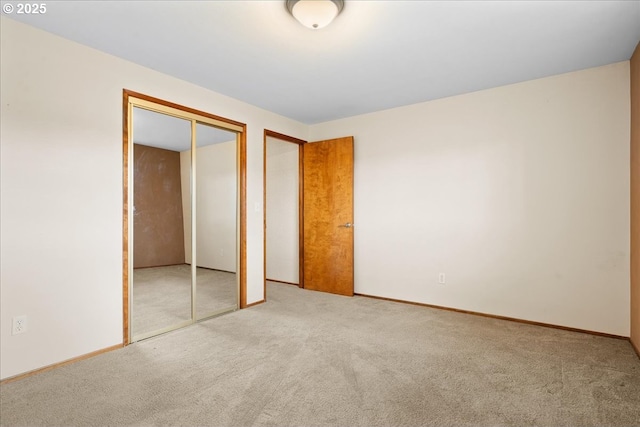 unfurnished bedroom with carpet floors and baseboards