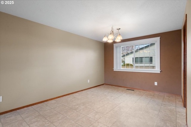 unfurnished room with light floors, baseboards, visible vents, and a notable chandelier