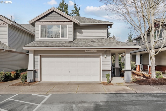 view of front of home with a garage, driveway, and a shingled roof