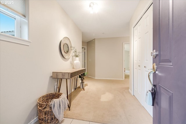 foyer entrance with carpet flooring and baseboards