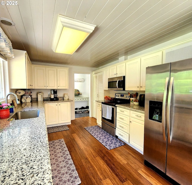 97640 Kadora Ln, North Bend, OR 97459 - kitchen with appliances with stainless steel finishes, a sink, wooden ceiling, light stone counters, and dark wood-style floors