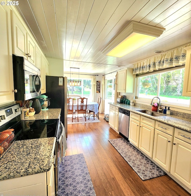 97640 Kadora Ln, North Bend, OR 97459 - kitchen featuring appliances with stainless steel finishes, a sink, wooden ceiling, hardwood / wood-style floors, and pendant lighting