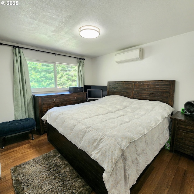 97640 Kadora Ln, North Bend, OR 97459 - bedroom featuring an AC wall unit, wood finished floors, and a textured ceiling