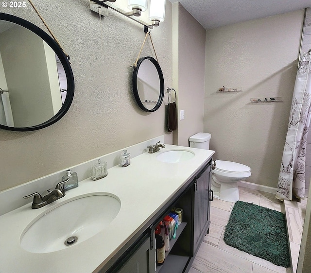 97640 Kadora Ln, North Bend, OR 97459 - bathroom featuring toilet, a textured wall, tile patterned floors, and double vanity