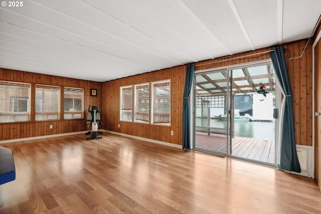 50350 Cowens Rd Unit 26/27, Scappoose, OR 97056 - unfurnished living room featuring wooden walls, wood finished floors, and baseboards