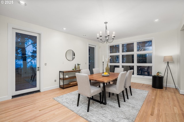 dining space featuring a notable chandelier and light hardwood / wood-style flooring