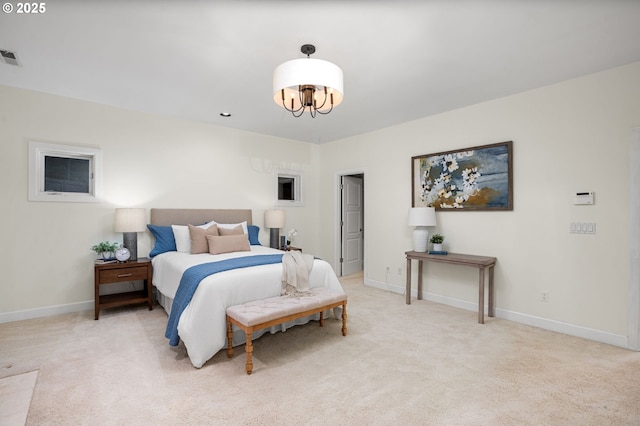 bedroom with an inviting chandelier, light colored carpet, and baseboards