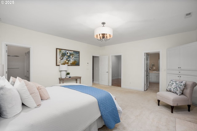 bedroom featuring baseboards, visible vents, ensuite bath, light carpet, and a notable chandelier