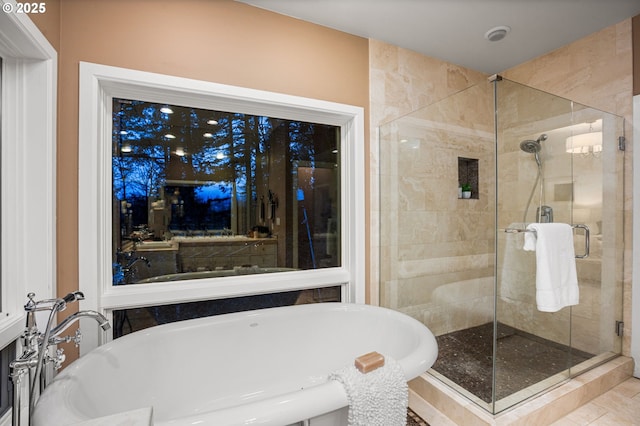 bathroom with separate shower and tub