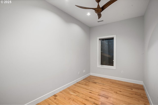 empty room featuring a ceiling fan, baseboards, visible vents, and light wood-type flooring