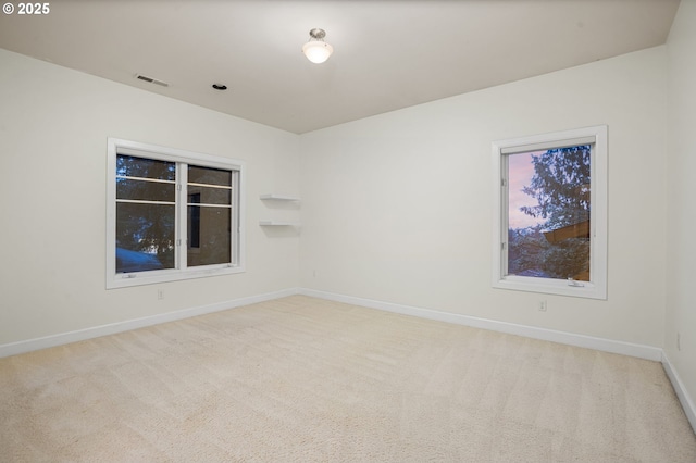 unfurnished room with visible vents, carpet flooring, and baseboards