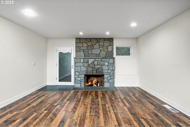 unfurnished living room with dark hardwood / wood-style flooring and a fireplace