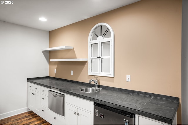 kitchen featuring open shelves, stainless steel dishwasher, and white cabinetry