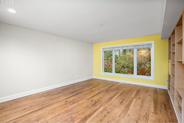 empty room with visible vents, recessed lighting, light wood-style floors, and baseboards