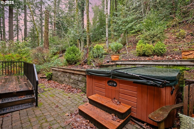 view of patio with a wooden deck and a hot tub