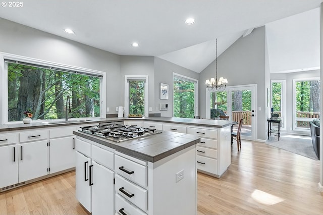 10585 SW 161st Ct, Beaverton, OR 97007 - kitchen with stainless steel gas stovetop, light wood-style flooring, a chandelier, recessed lighting, and healthy amount of natural light