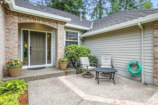 10585 SW 161st Ct, Beaverton, OR 97007 - property entrance featuring brick siding and a patio