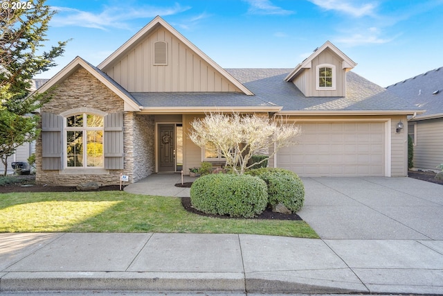 view of front of property with a garage and a front lawn