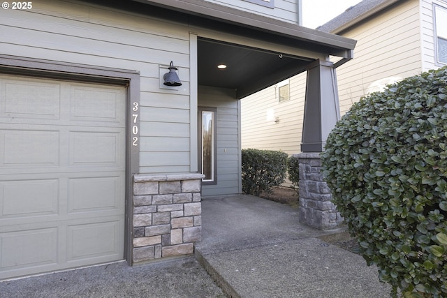 view of exterior entry featuring a garage