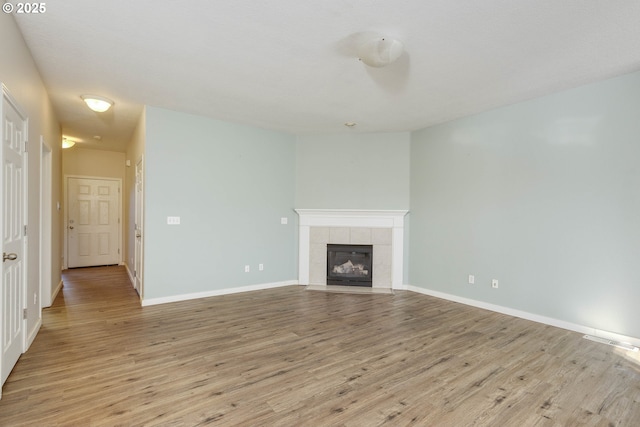 unfurnished living room featuring a fireplace and light wood-type flooring