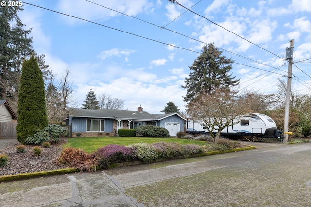 ranch-style house with a garage and a front lawn