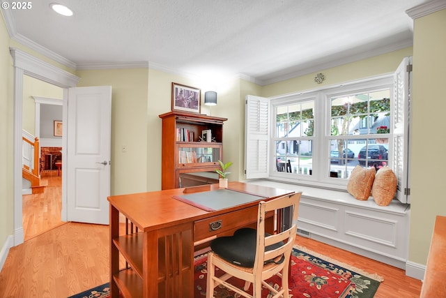 office space with recessed lighting, ornamental molding, light wood-type flooring, and visible vents