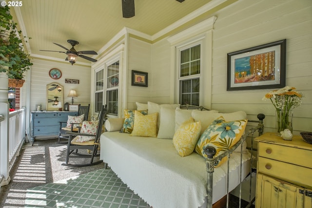 exterior space featuring ornamental molding, a ceiling fan, and carpet flooring