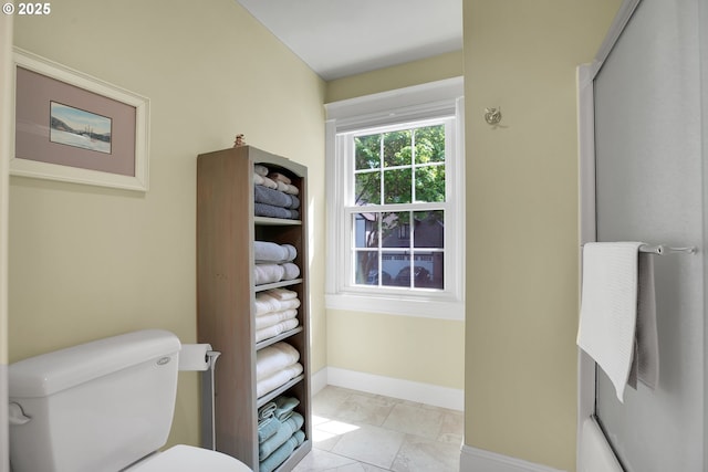 bathroom with toilet and baseboards