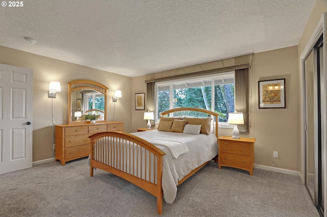 bedroom with light carpet, a textured ceiling, and baseboards